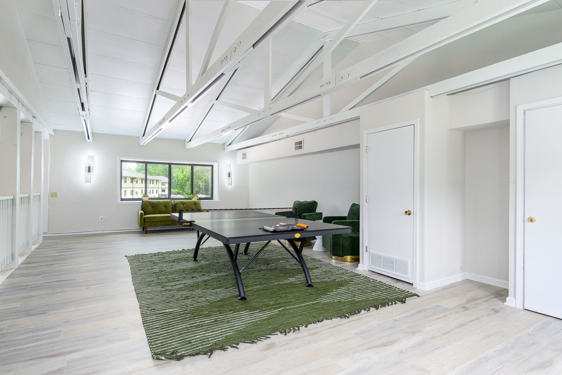 There is a ping pong table in the middle of the room.