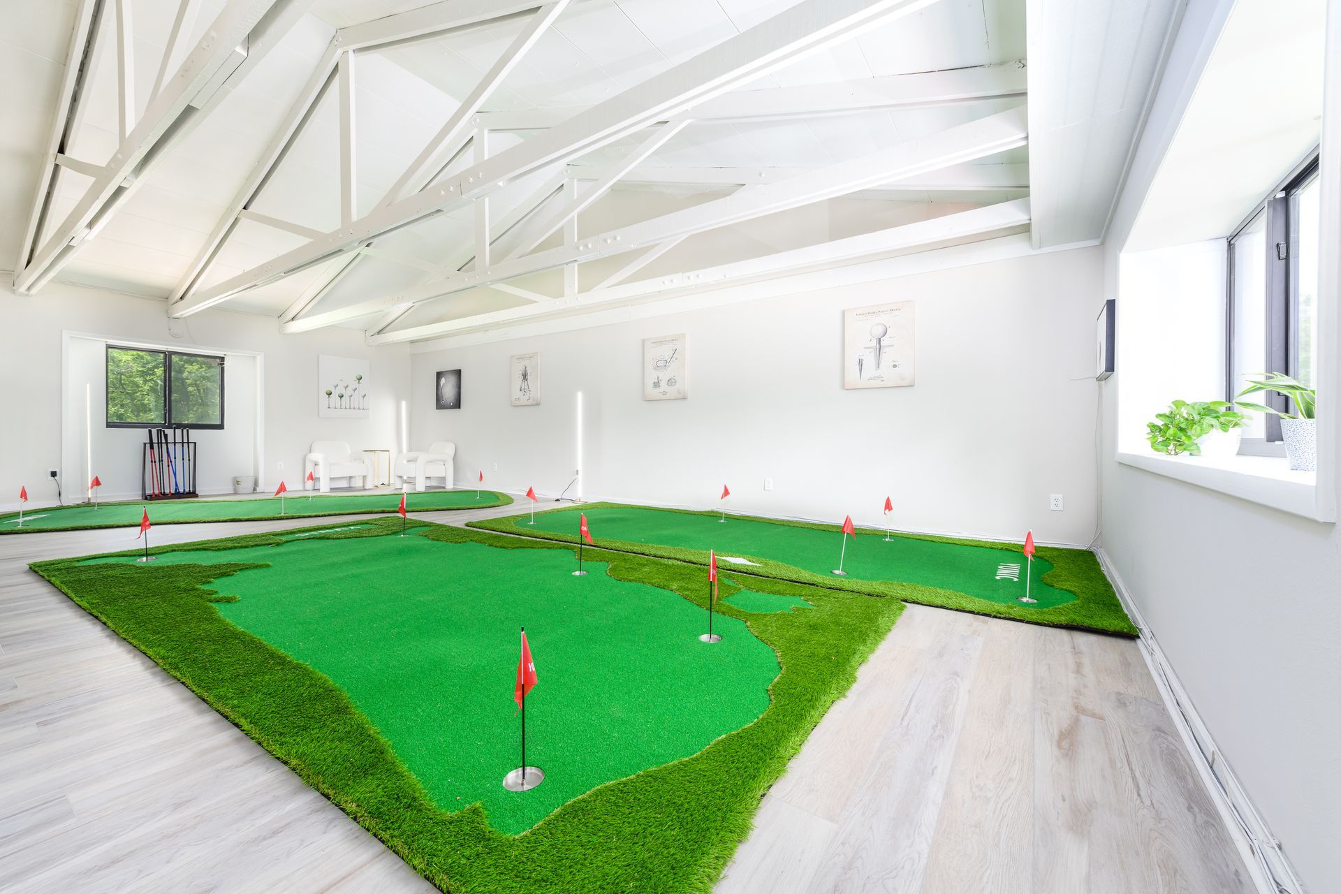 There is a putting green in the middle of the room.