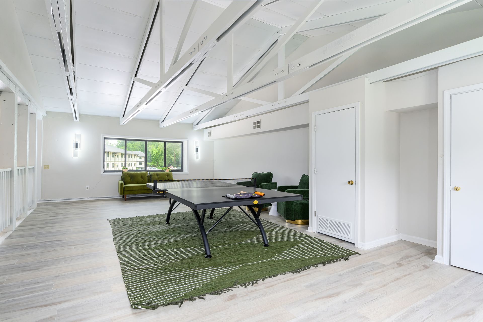 There is a ping pong table in the middle of the room.
