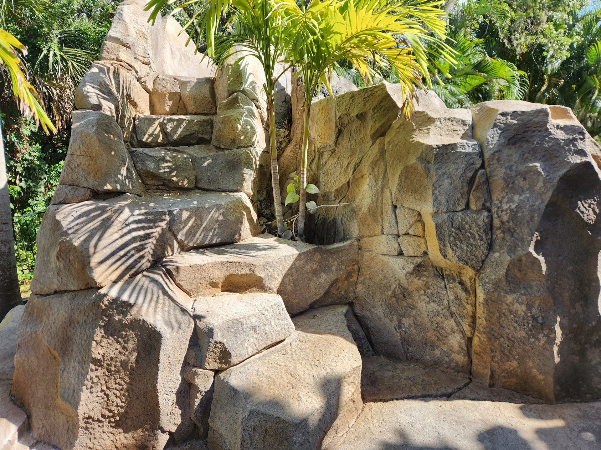 Stone steps and rock formations in a tropical outdoor setting.