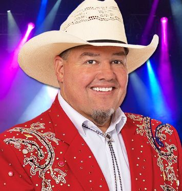 A man wearing a cowboy hat and a red jacket