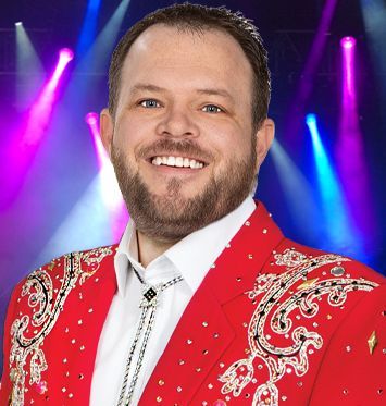 A man with a beard is wearing a red jacket