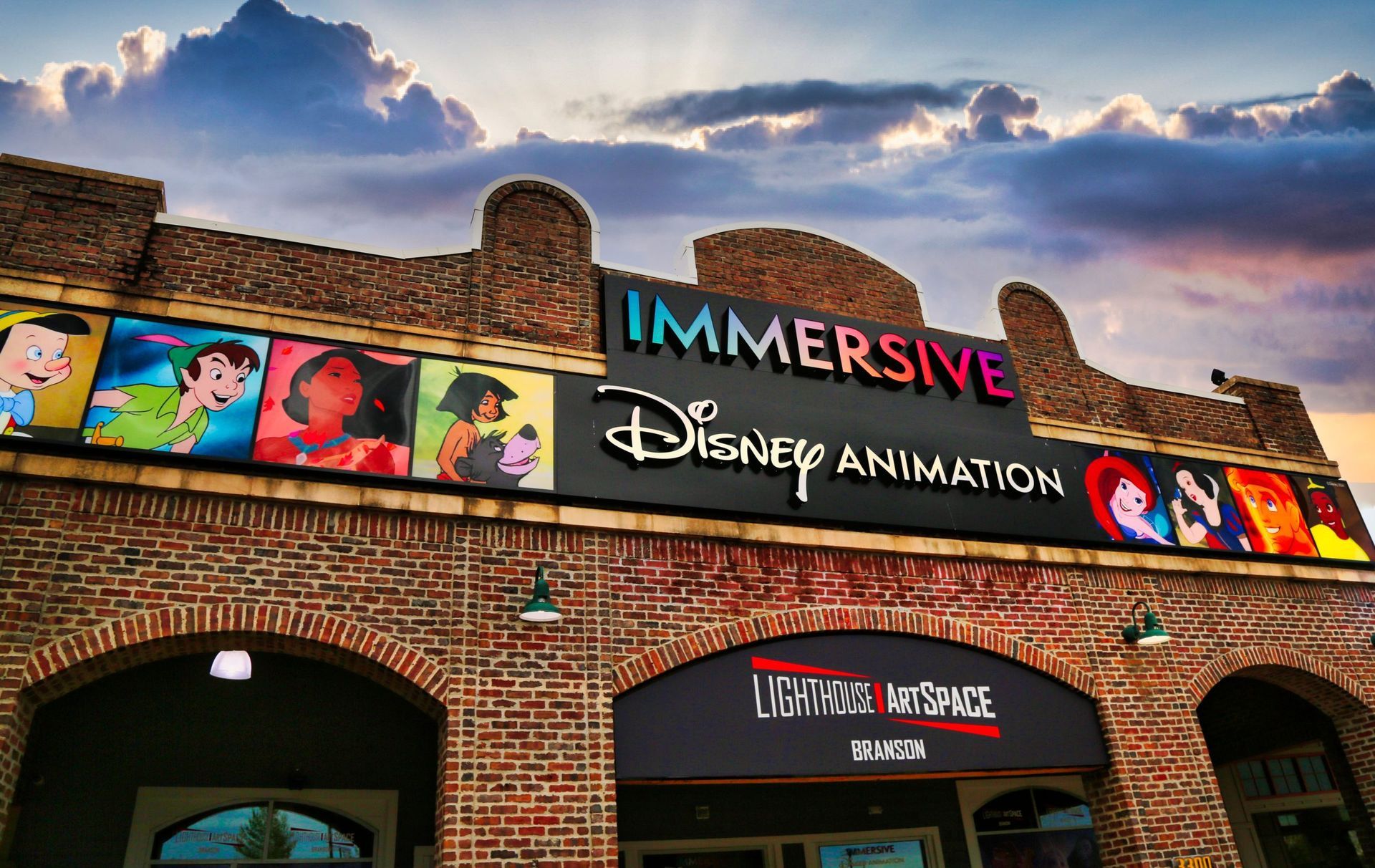 A brick building with a sign that says immersive disney animation