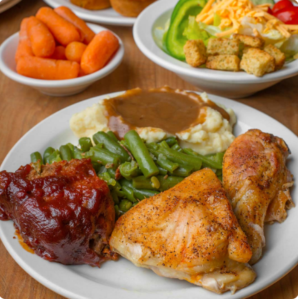 A white plate topped with chicken green beans mashed potatoes and gravy