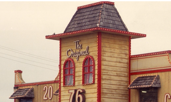 A wooden building with a roof that says the original on it