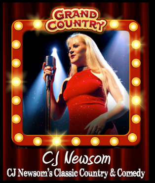 A woman is holding a guitar in front of a red curtain.