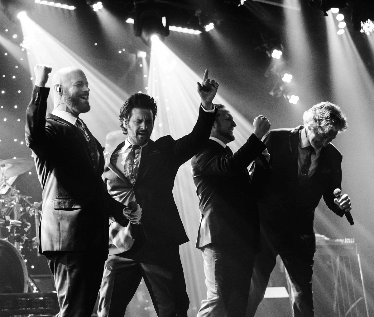Four performers in western attire promote a country music show in Branson, Missouri, featuring the title Down Home Country.