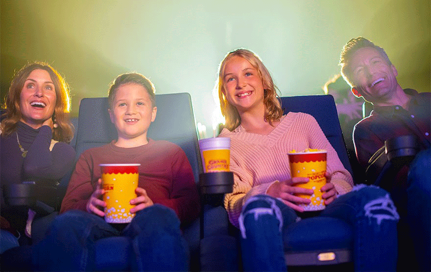 Four performers in western attire promote a country music show in Branson, Missouri, featuring the title Down Home Country.