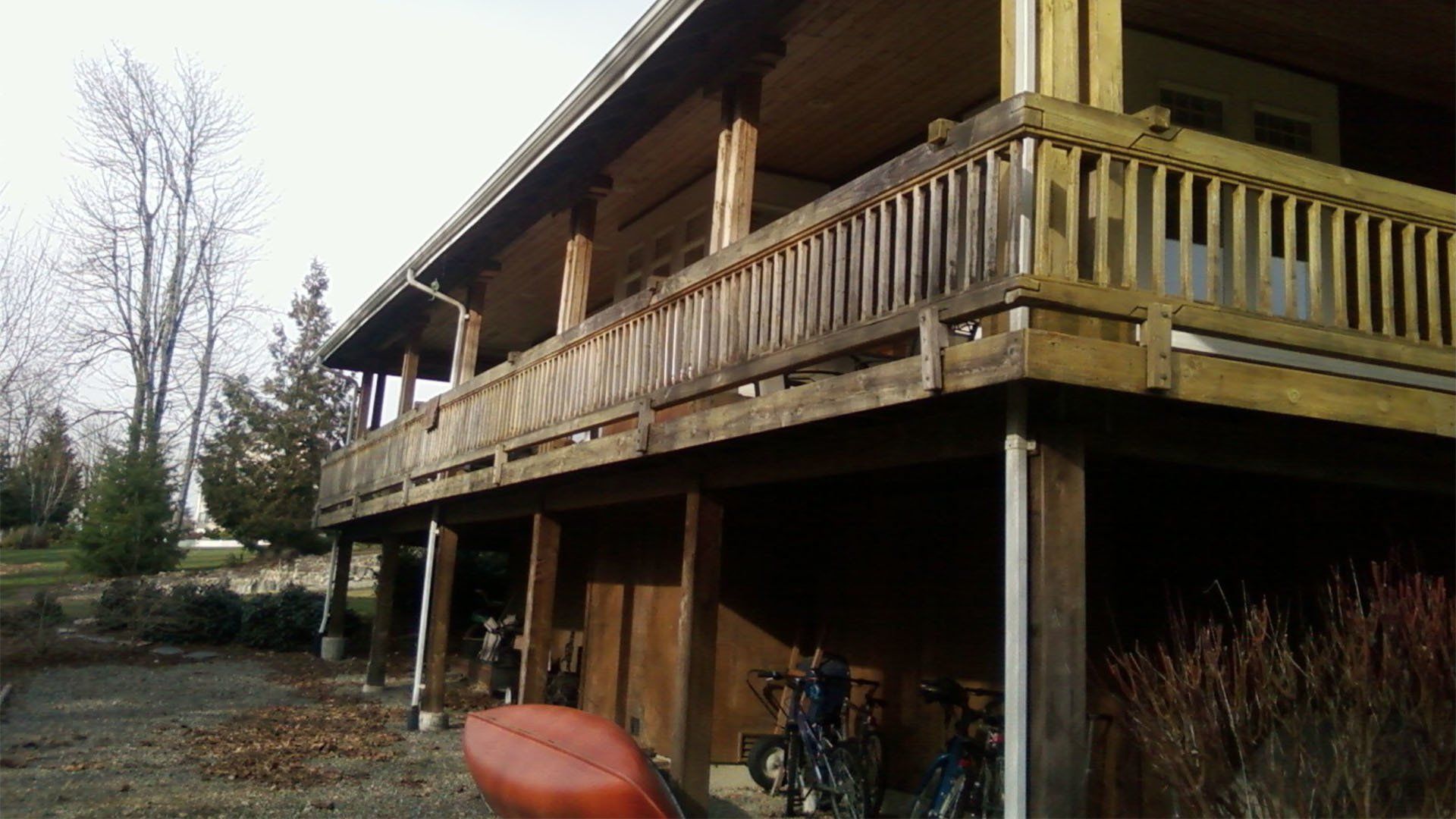 A white truck is parked in front of a large house