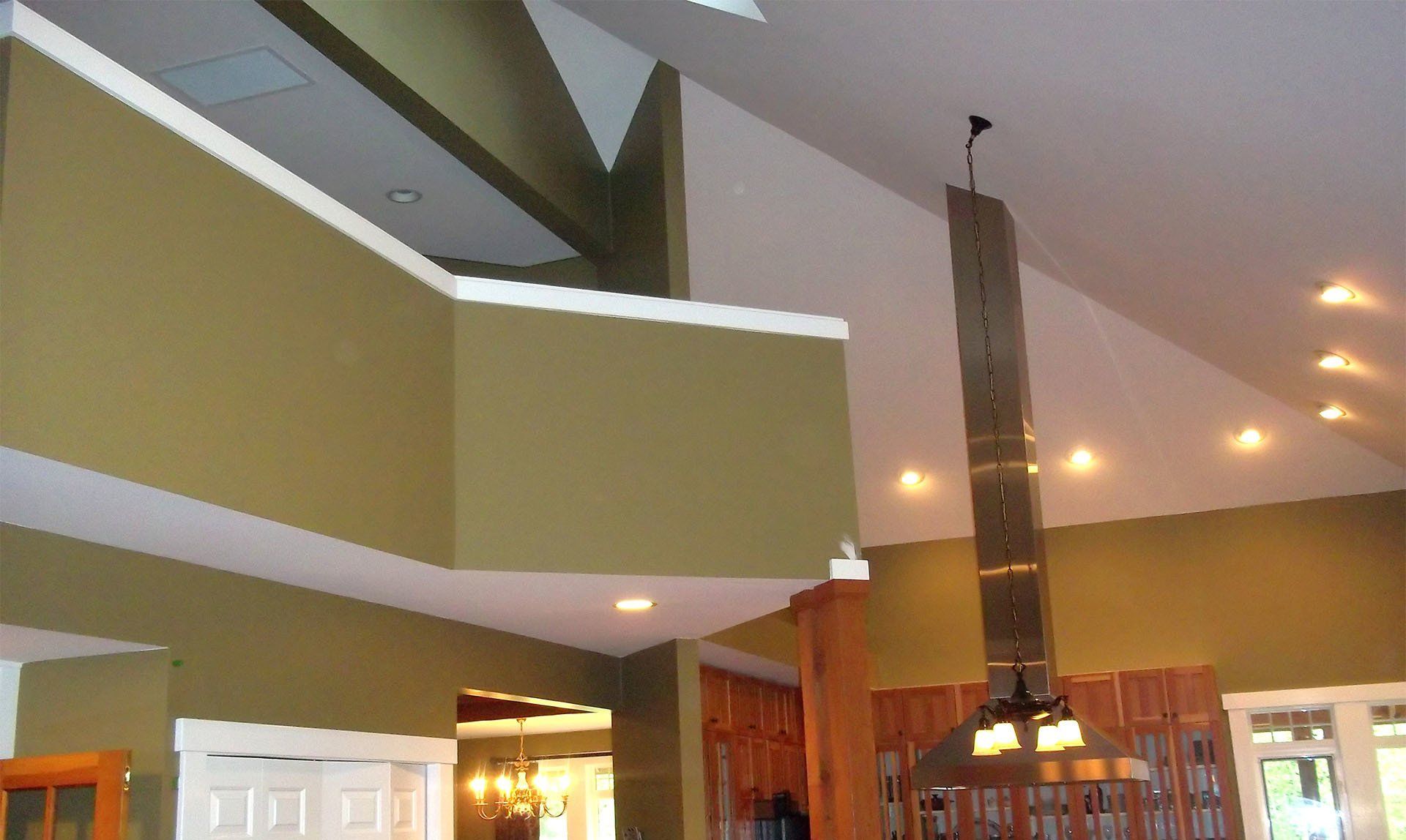 A kitchen with a vaulted ceiling and a chimney