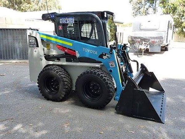 A toyota skid steer is parked in a parking lot