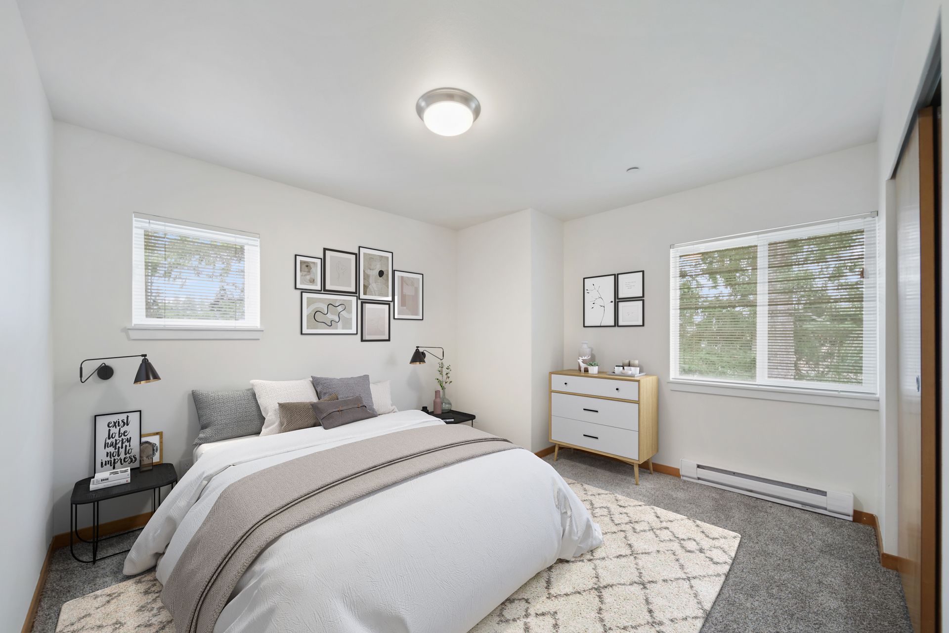 Bright modern bedroom with a bed, dresser, nightstand, and two windows on carpeted floor.