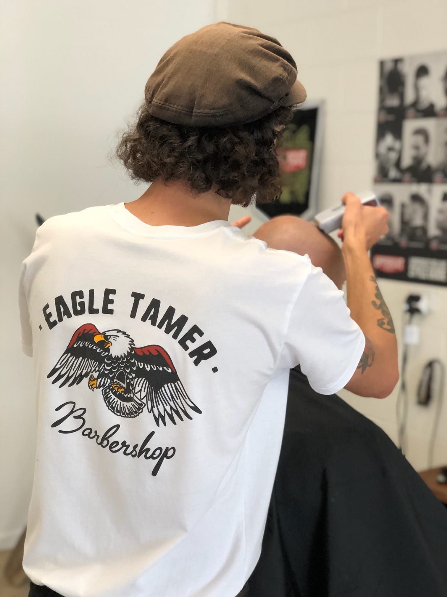 Barber with curly hair, wearing a