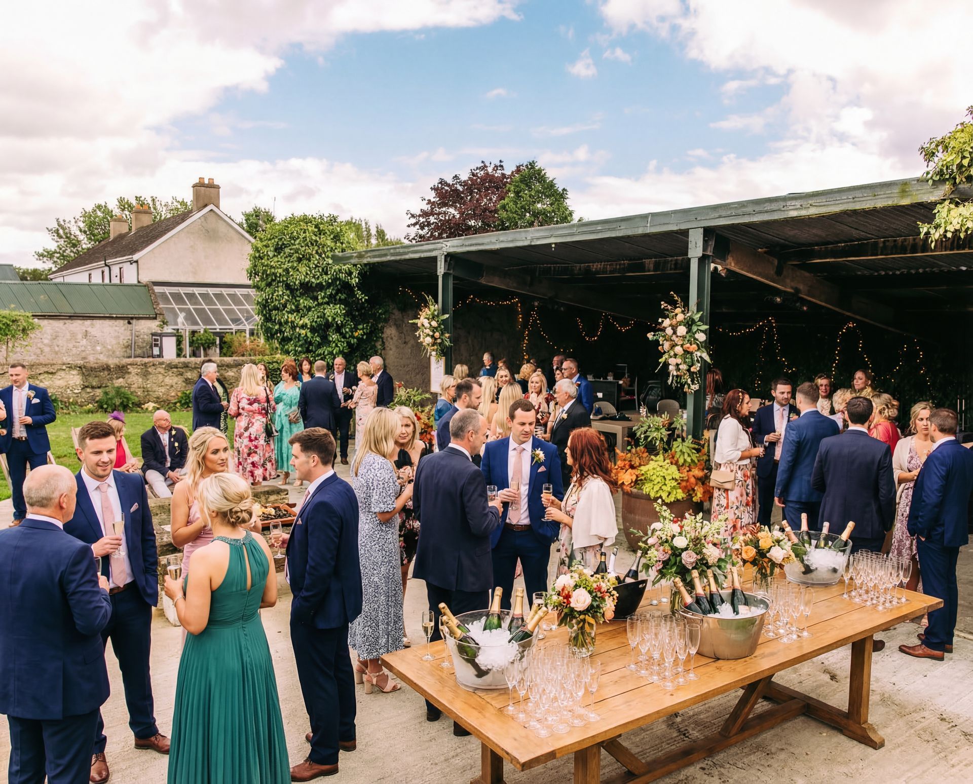 Decorated barn reception with round tables, pink balloons, and buffet tables set for a celebration