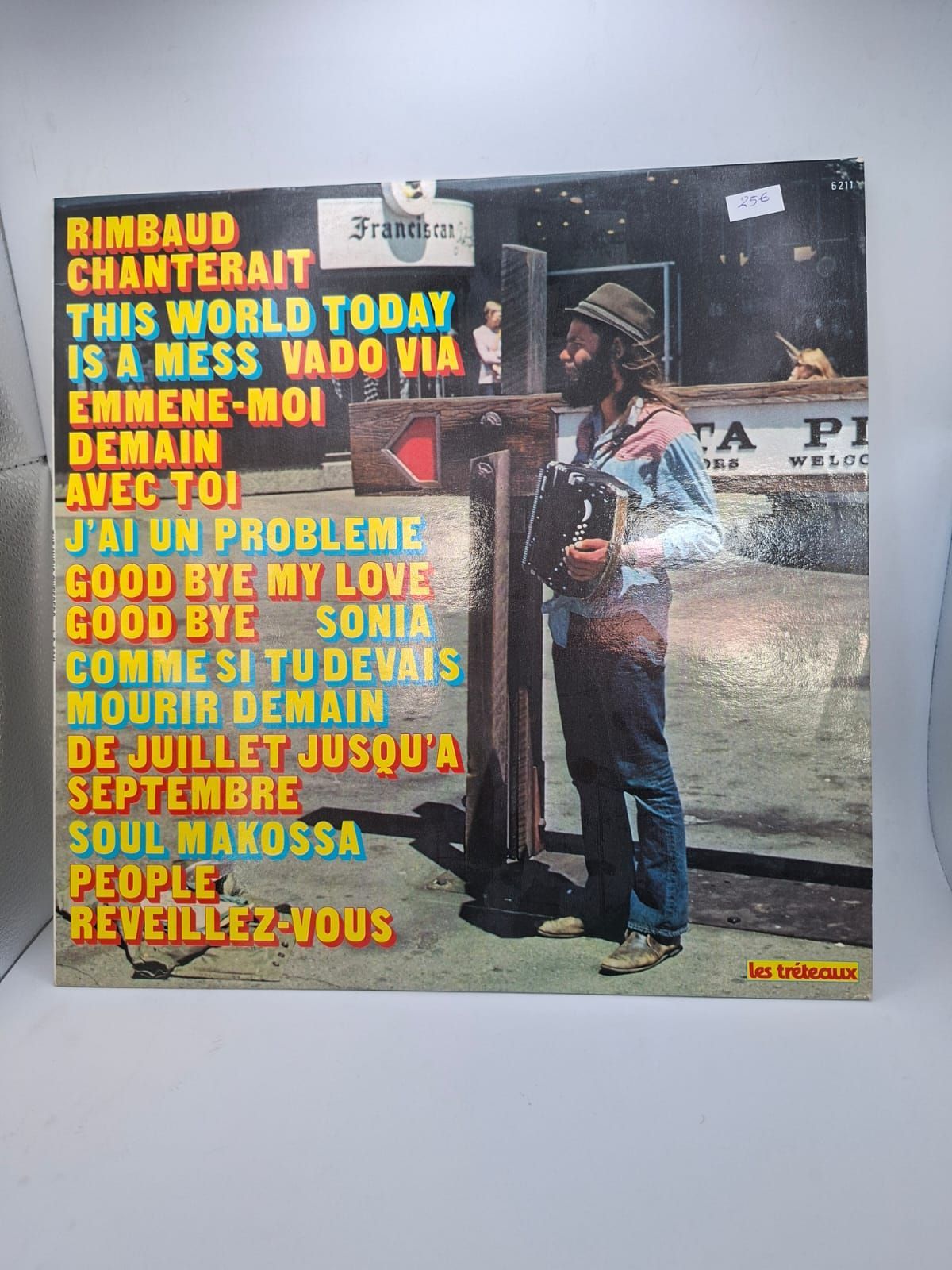 La copertina di un disco in vinile presenta la lista dei brani in testo giallo, accanto alla fotografia di una persona che suona la fisarmonica all'aperto.
