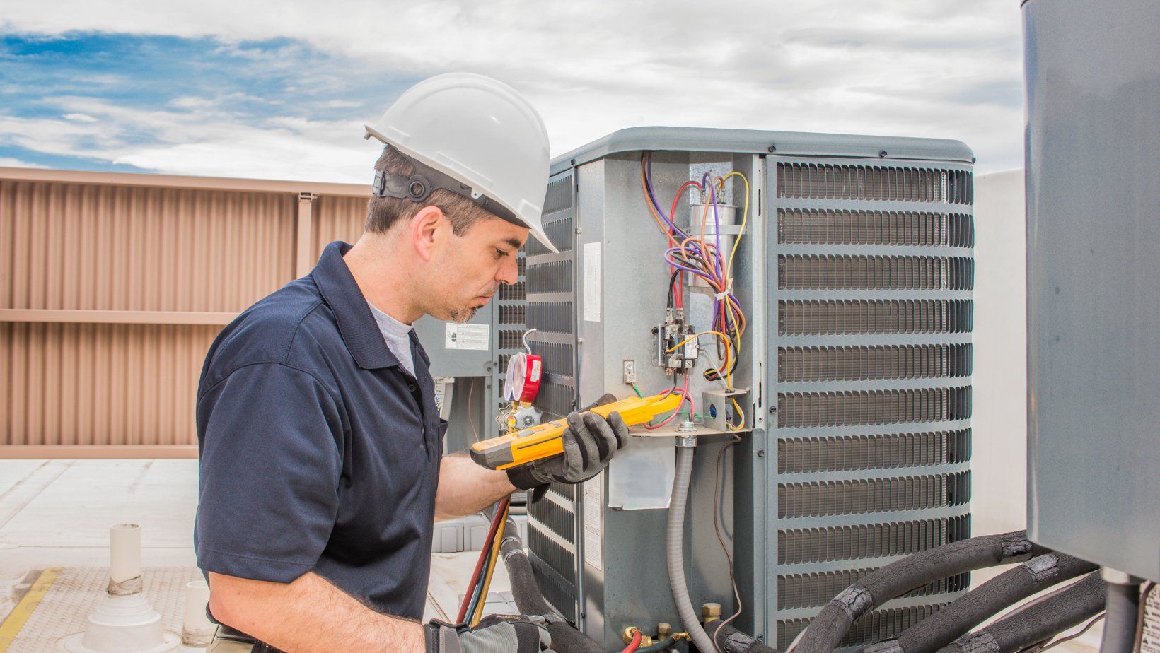 man repairing ac