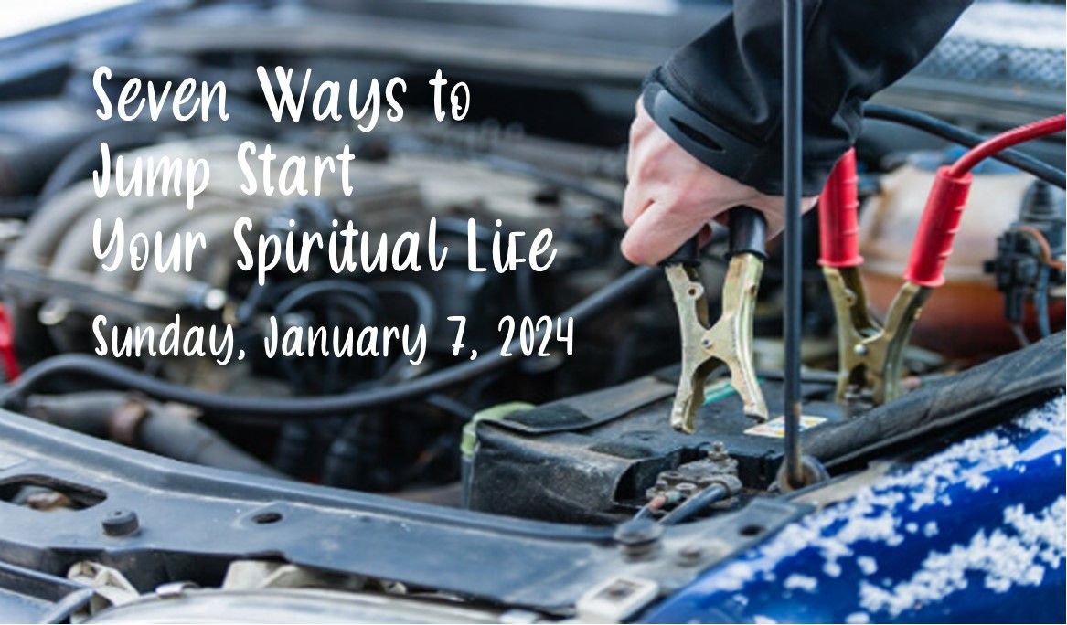 Person jump-starts car engine with cables