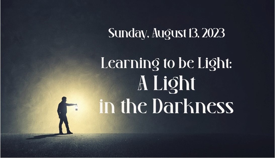 Person holding a light in a dark landscape;