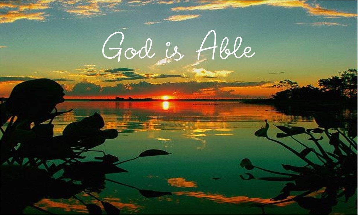 A sunset over a lake with the words god is able