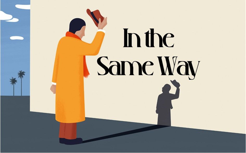 A man in a yellow coat is standing in front of a wall with the words `` in the same way '' written on it.