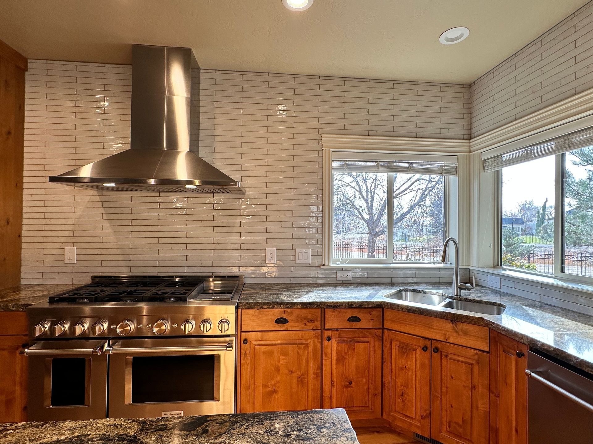 A kitchen with stainless steel appliances and wooden cabinets