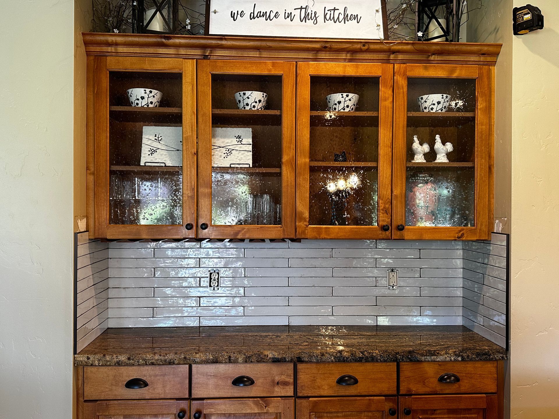 A kitchen with wooden cabinets and a sign that says 