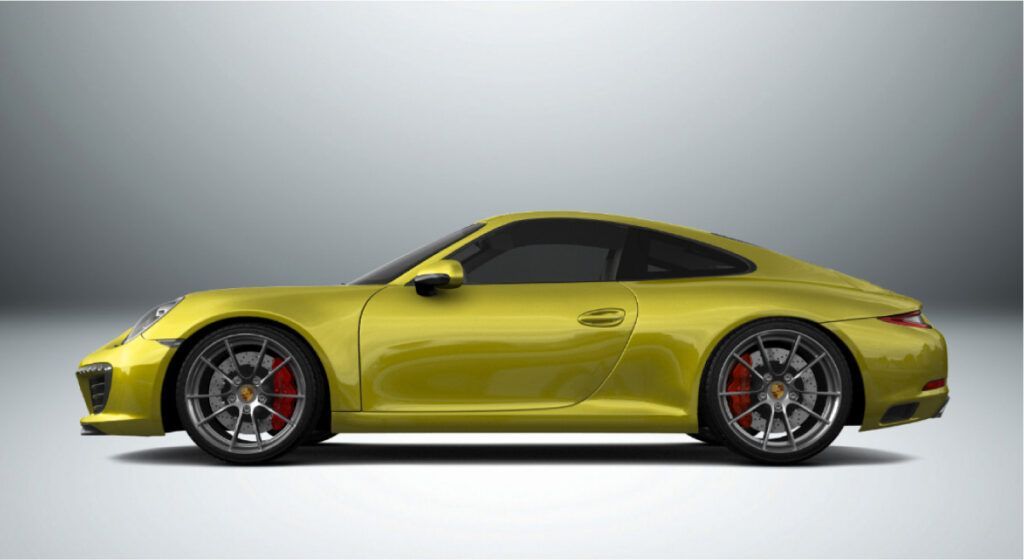 Um porsche 911 amarelo está sobre uma superfície branca.