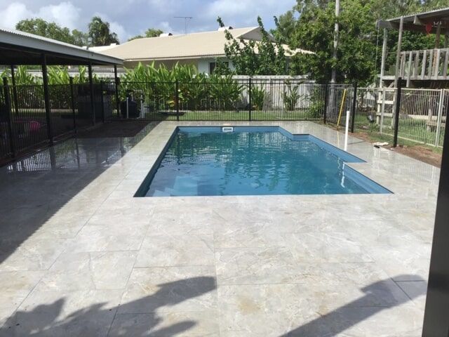 Clean Tiles with Big Swimming Pool and Plants behind — Paving in Darwin River, NT
