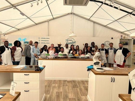 a room full of people in a kitchen set up for a bake off 
