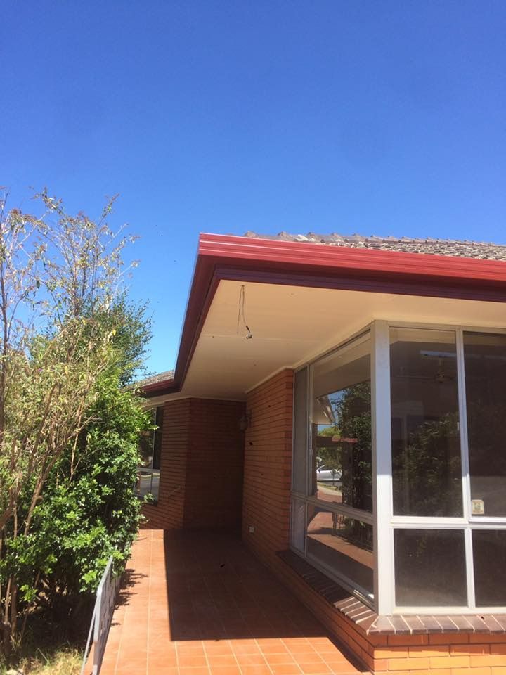 A Brick House With A Red Roof — Matt Walsh Plumbing in Wodonga, VIC