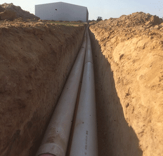 A Pipe Is Being Installed In A Trench — Matt Walsh Plumbing in Thurgoona, NSW