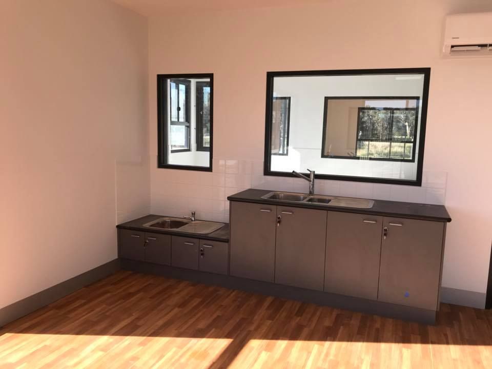 An Empty Kitchen With Two Sinks — Matt Walsh Plumbing in Thurgoona, NSW