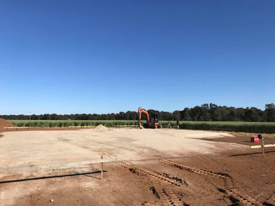 A Large Orange Excavator — Matt Walsh Plumbing in Thurgoona, NSW