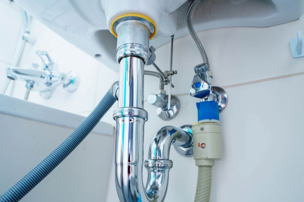 A bathroom sink with a hose attached to it. — Matt Walsh Plumbing in Thurgoona, NSW