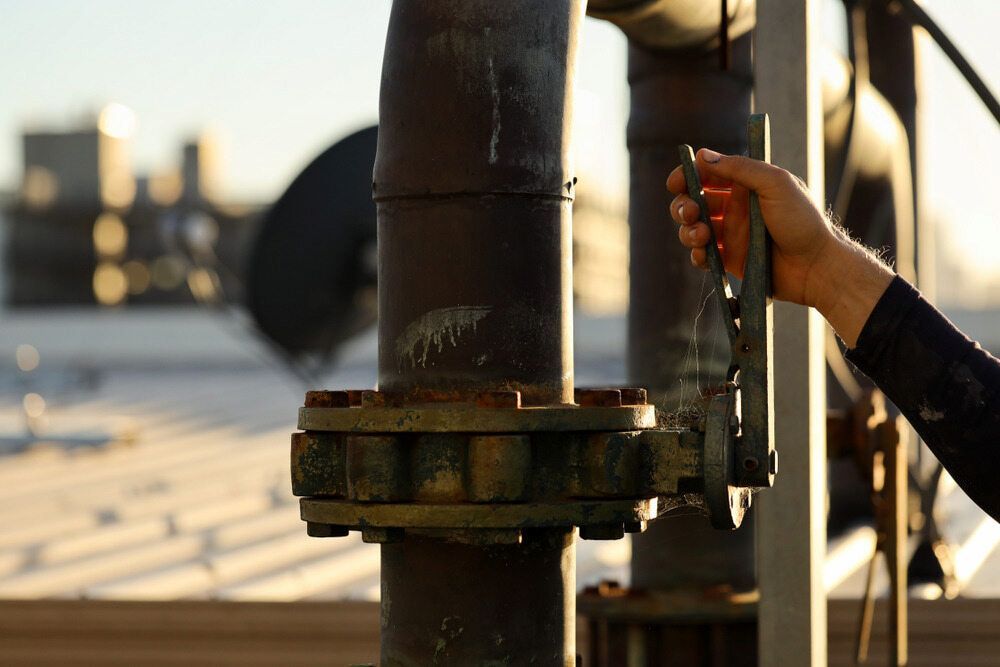 A Person Is Opening A Valve On A Pipe — Matt Walsh Plumbing in Wodonga, VIC