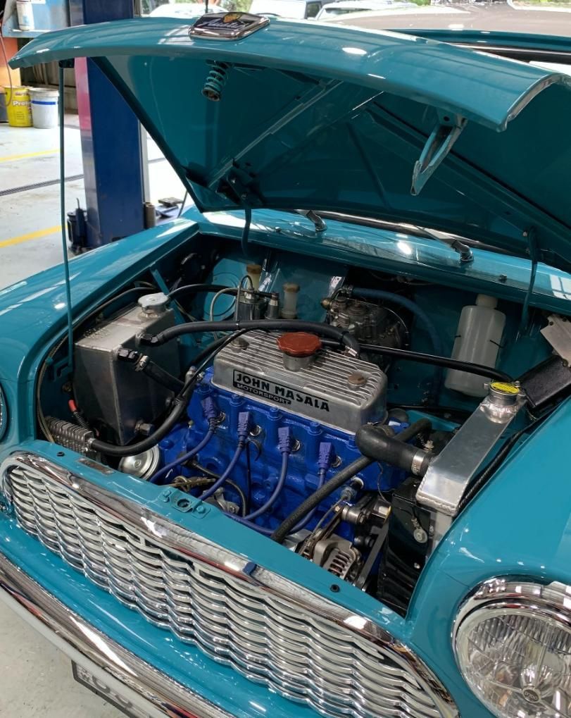 The Engine of a Blue Car is Shown With the Hood Open — Town & Country Removals In Taree, NSW
