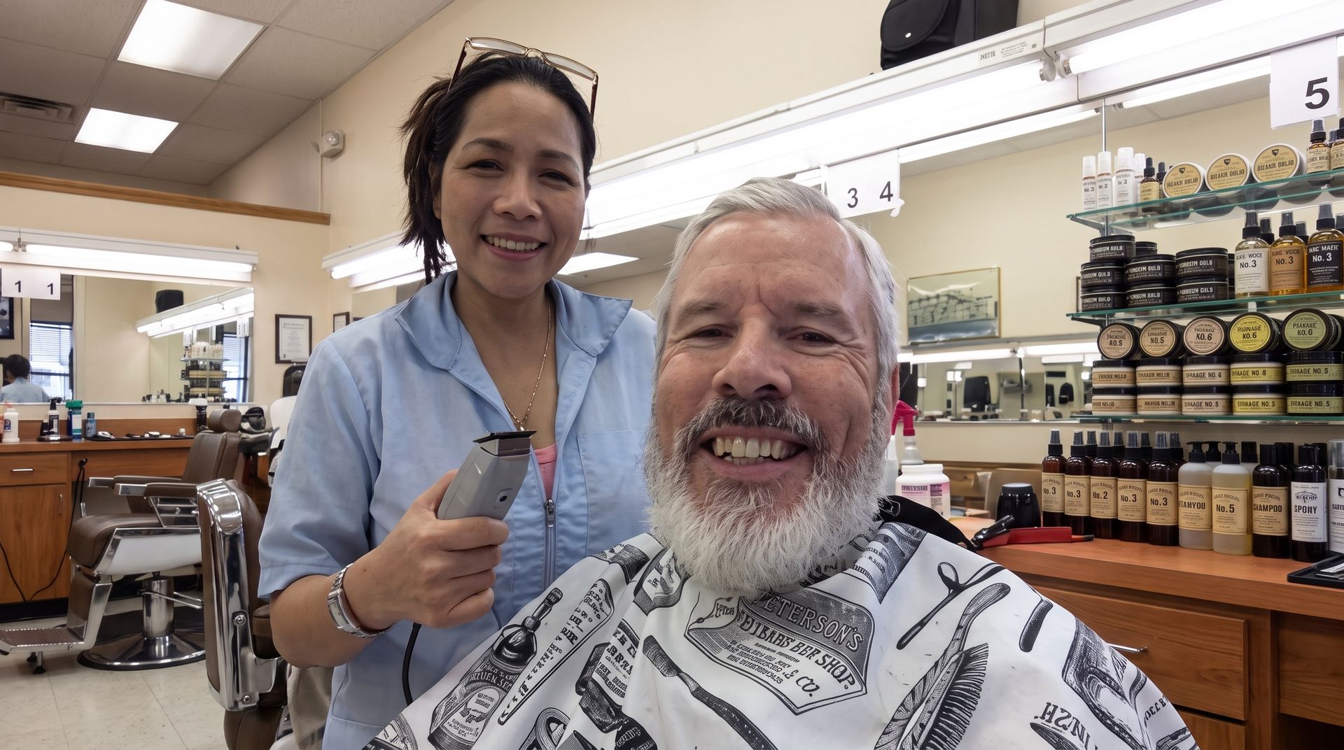 Barber trimming a bearded man’s beard with scissors and a comb
