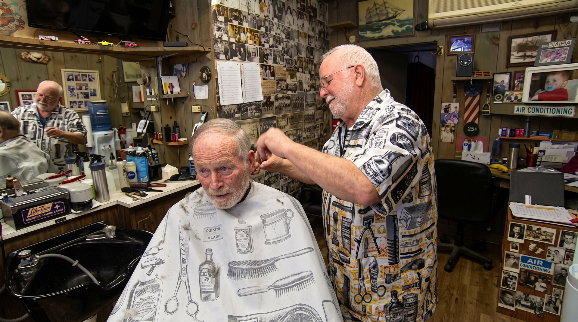 Person uses a comb to trim hair near the temple with scissors.
