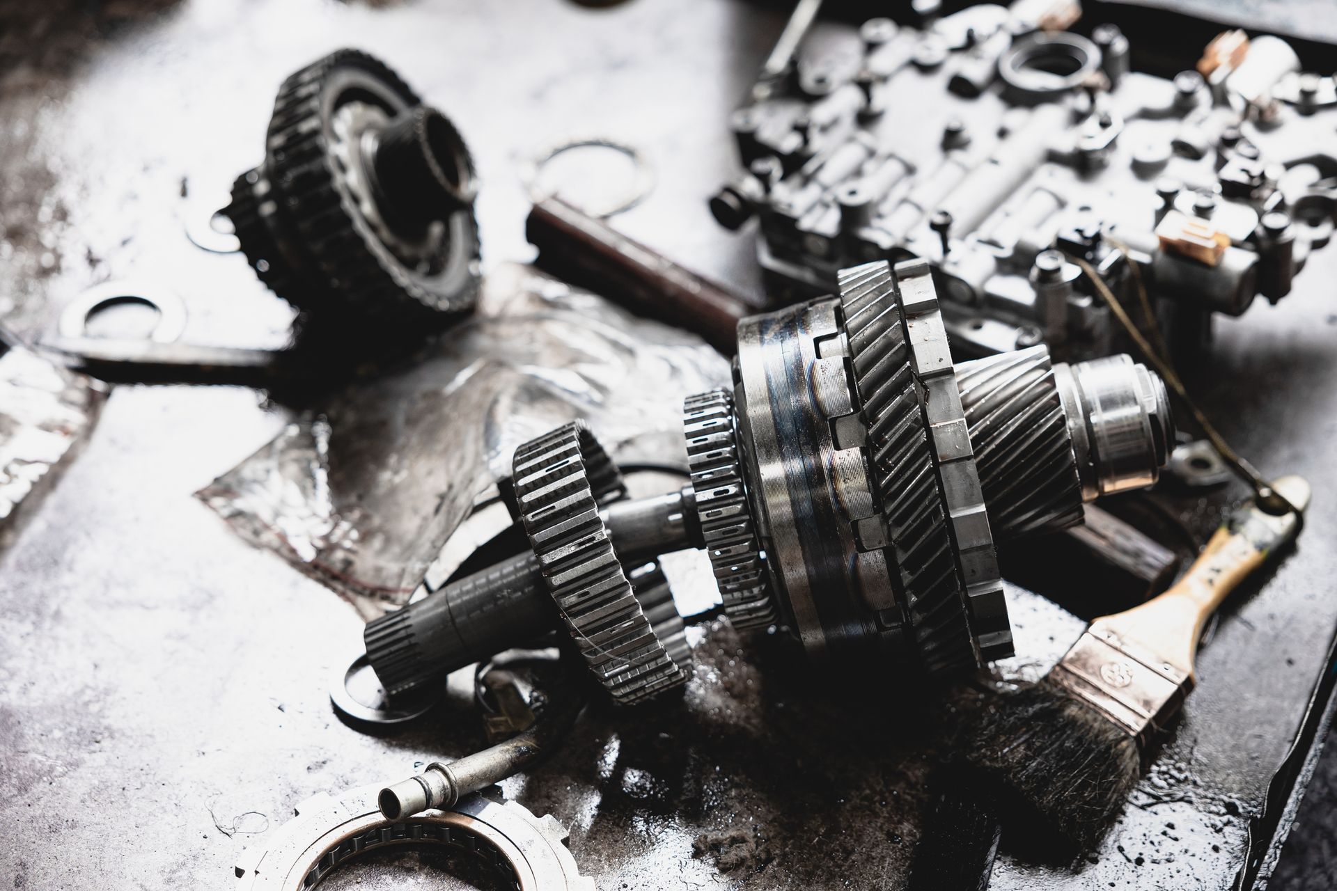 A bunch of gears and brushes are laying on a table.