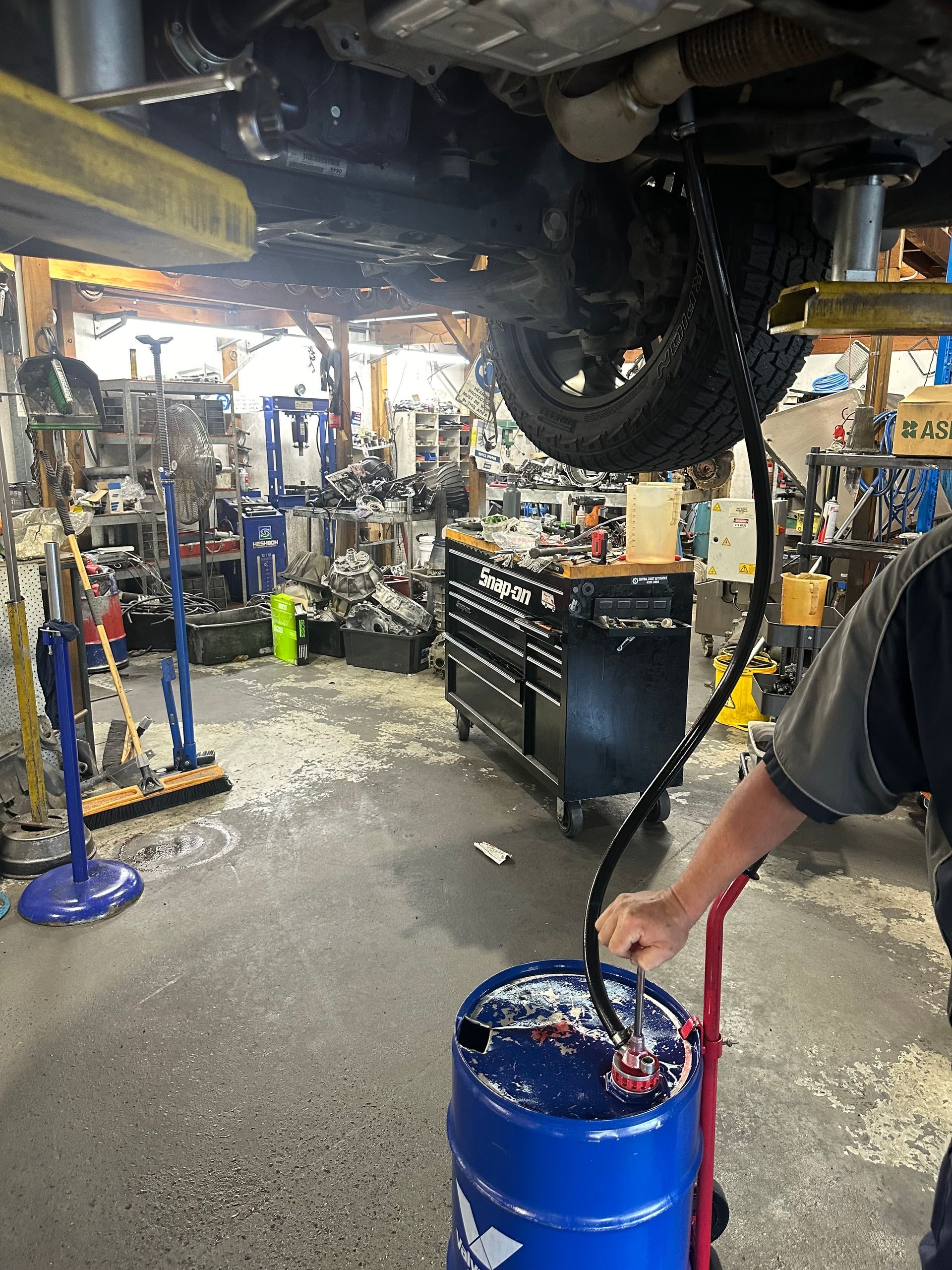 A person is changing the oil in a car.