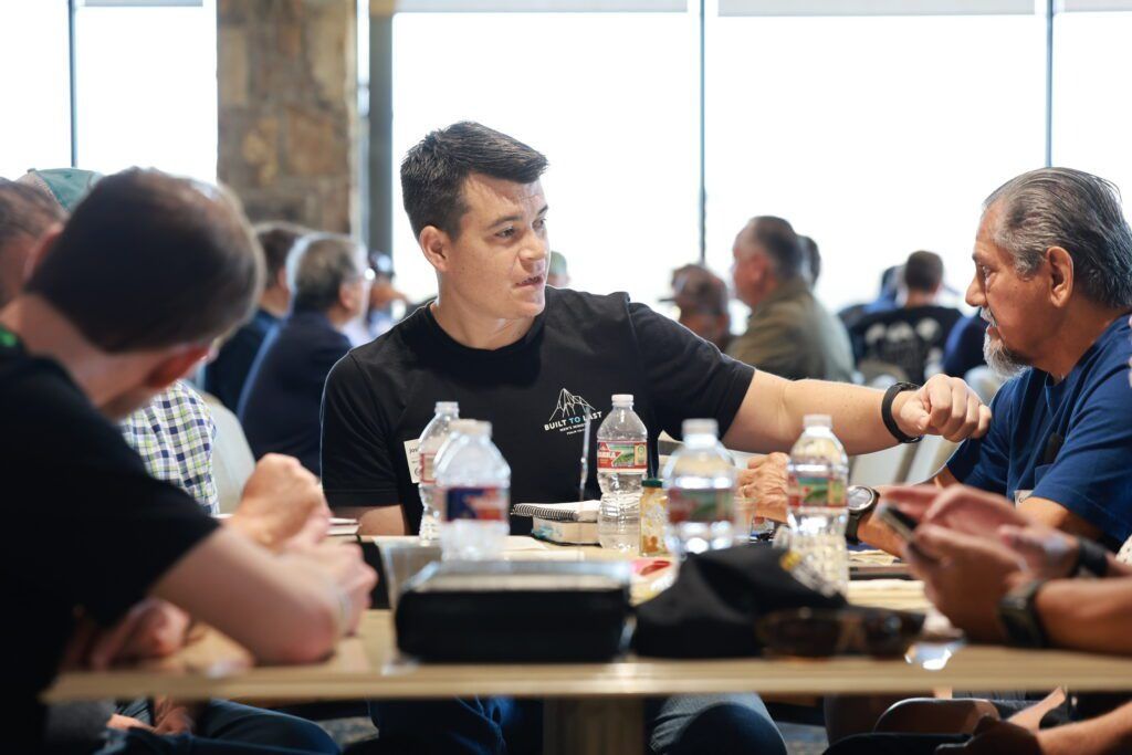 People chatting over a meal at a table in a bright restaurant or cafeteria