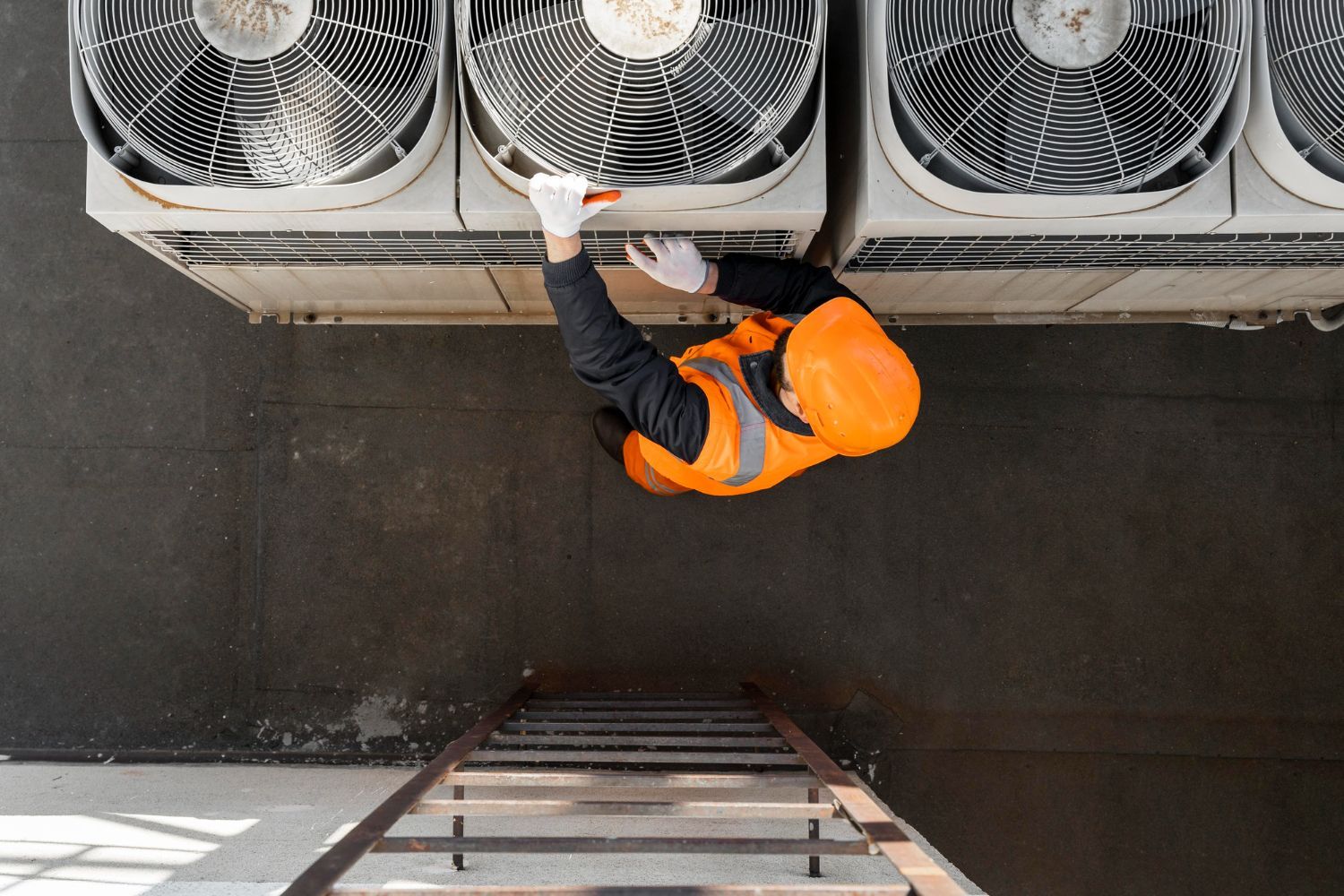 A man is checking up to fix an air conditioner.