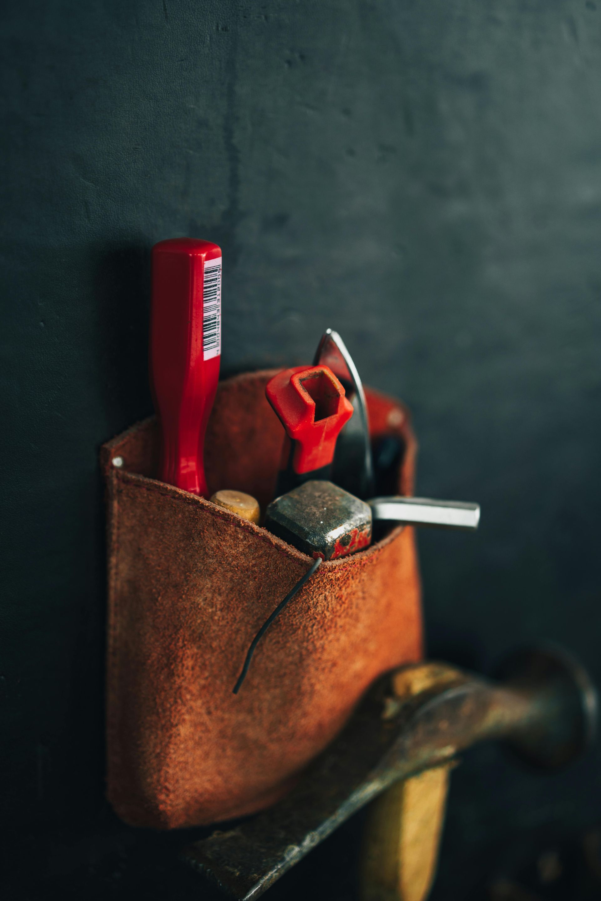 A man is using a drill to drill a hole in a piece of wood.