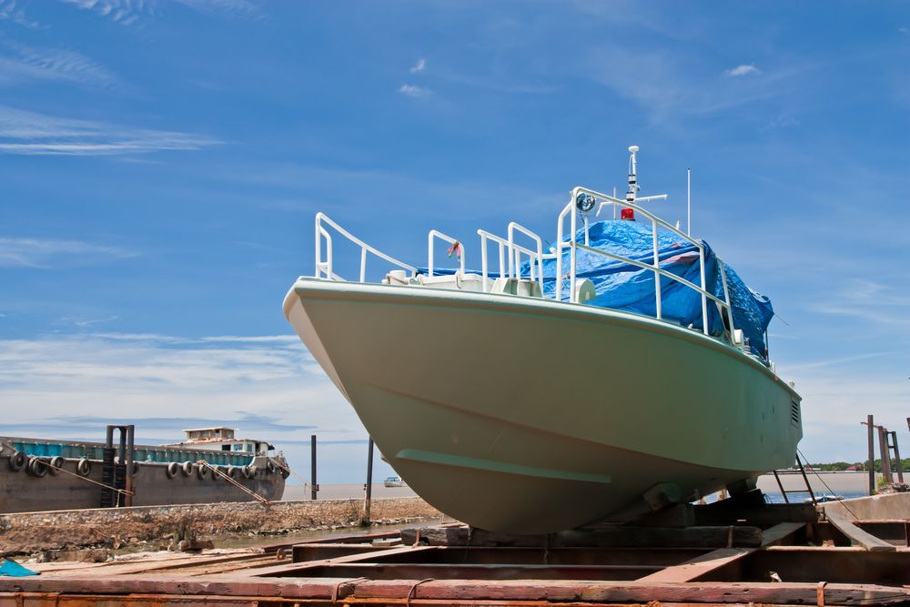 A large boat is sitting on top of a wooden platform.