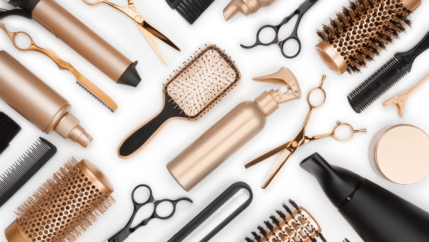 Assorted hair styling tools and cosmetics arranged on a white background