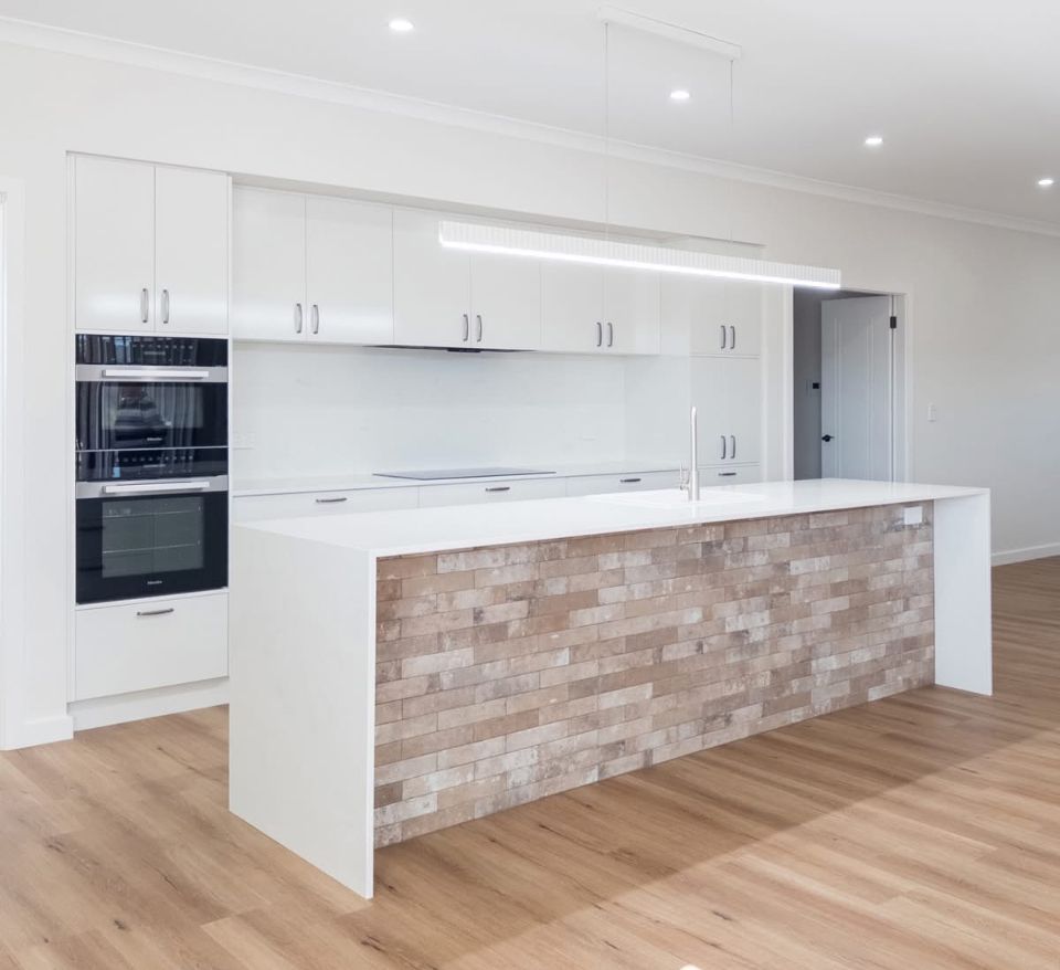 There is a large island in the middle of the kitchen.