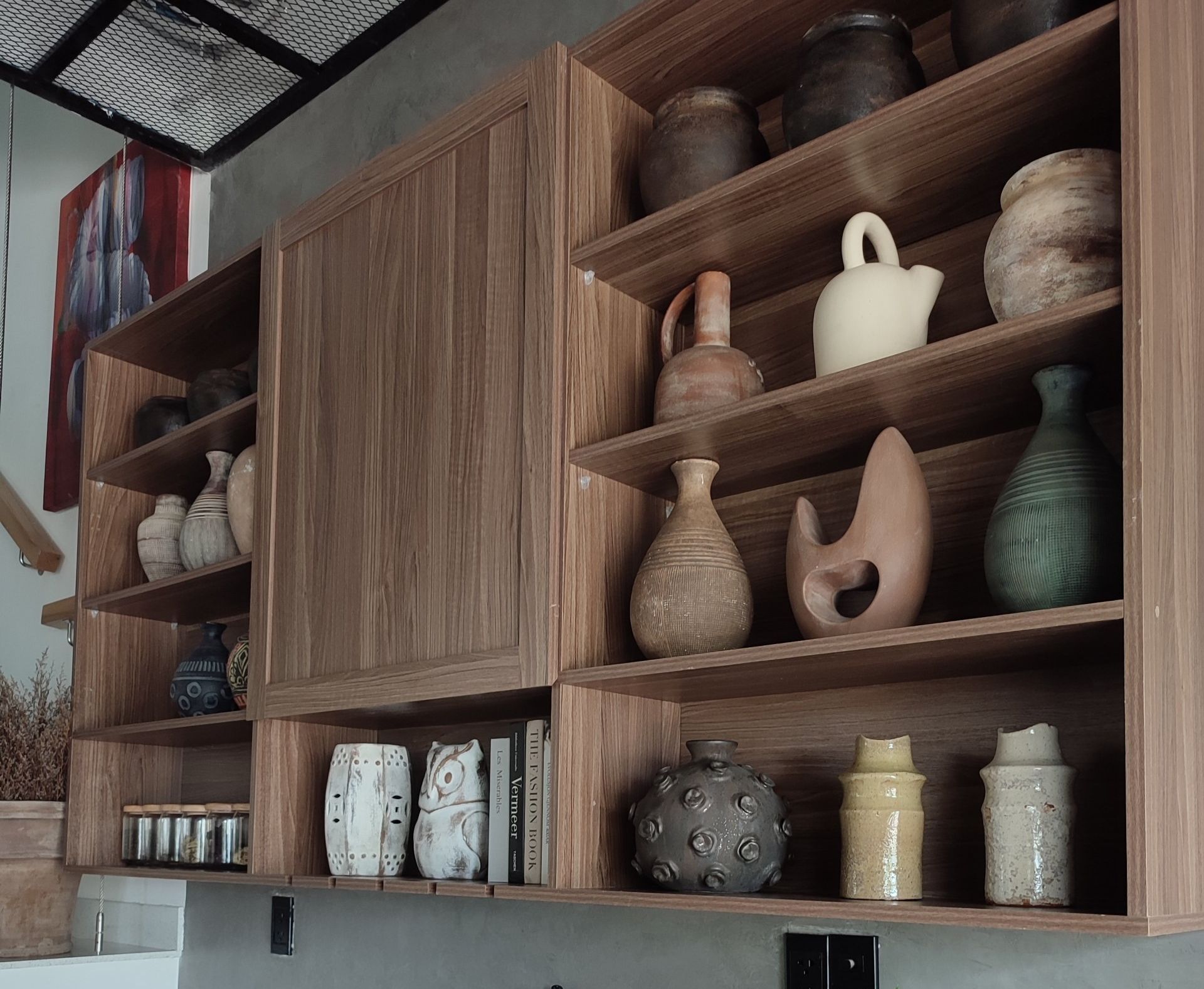 A shelf with a lot of vases on it