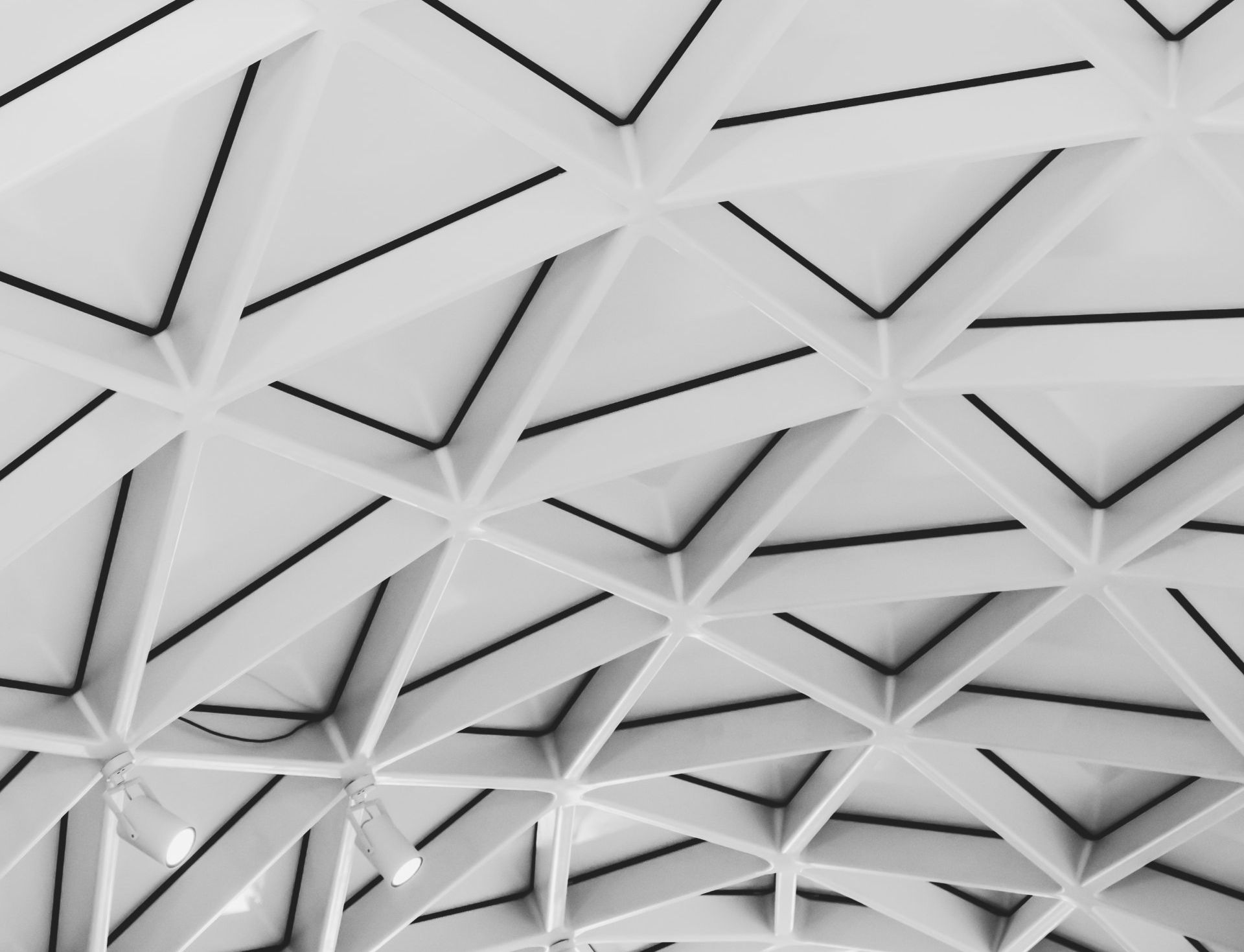 A close up of a white ceiling with black lines