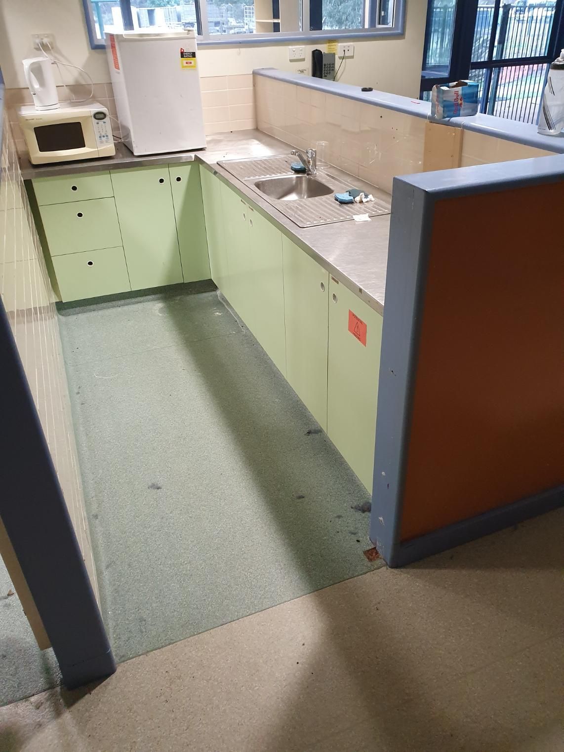A Kitchen with Green Cabinets, a Sink, a Microwave and A Refrigerator — Entire Trades in Maitland, NSW