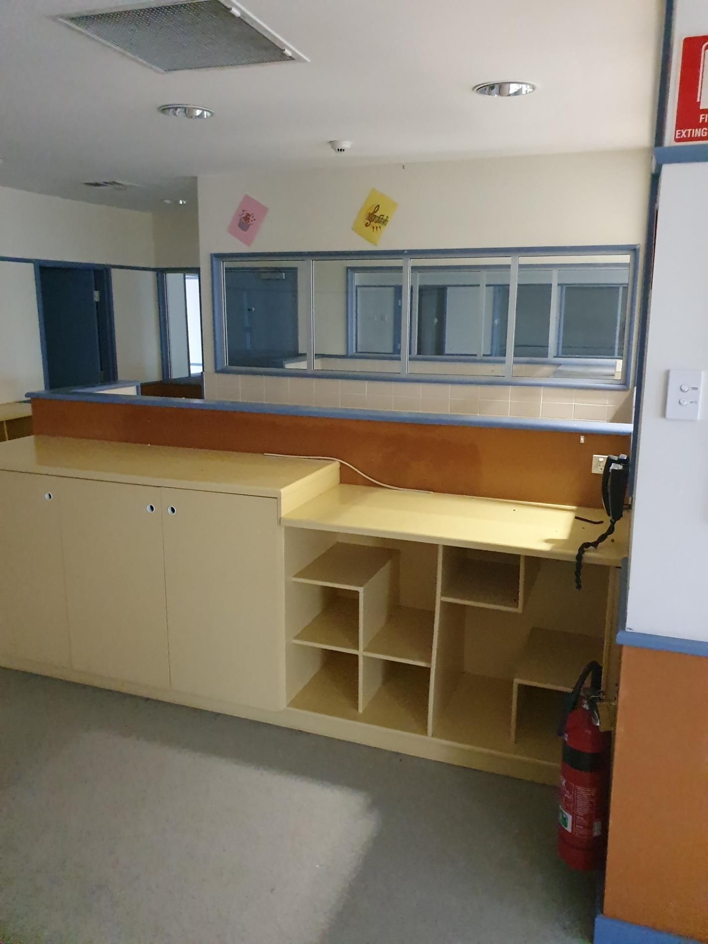An Empty Room with A Fire Extinguisher on The Floor — Entire Trades in Singleton, NSW